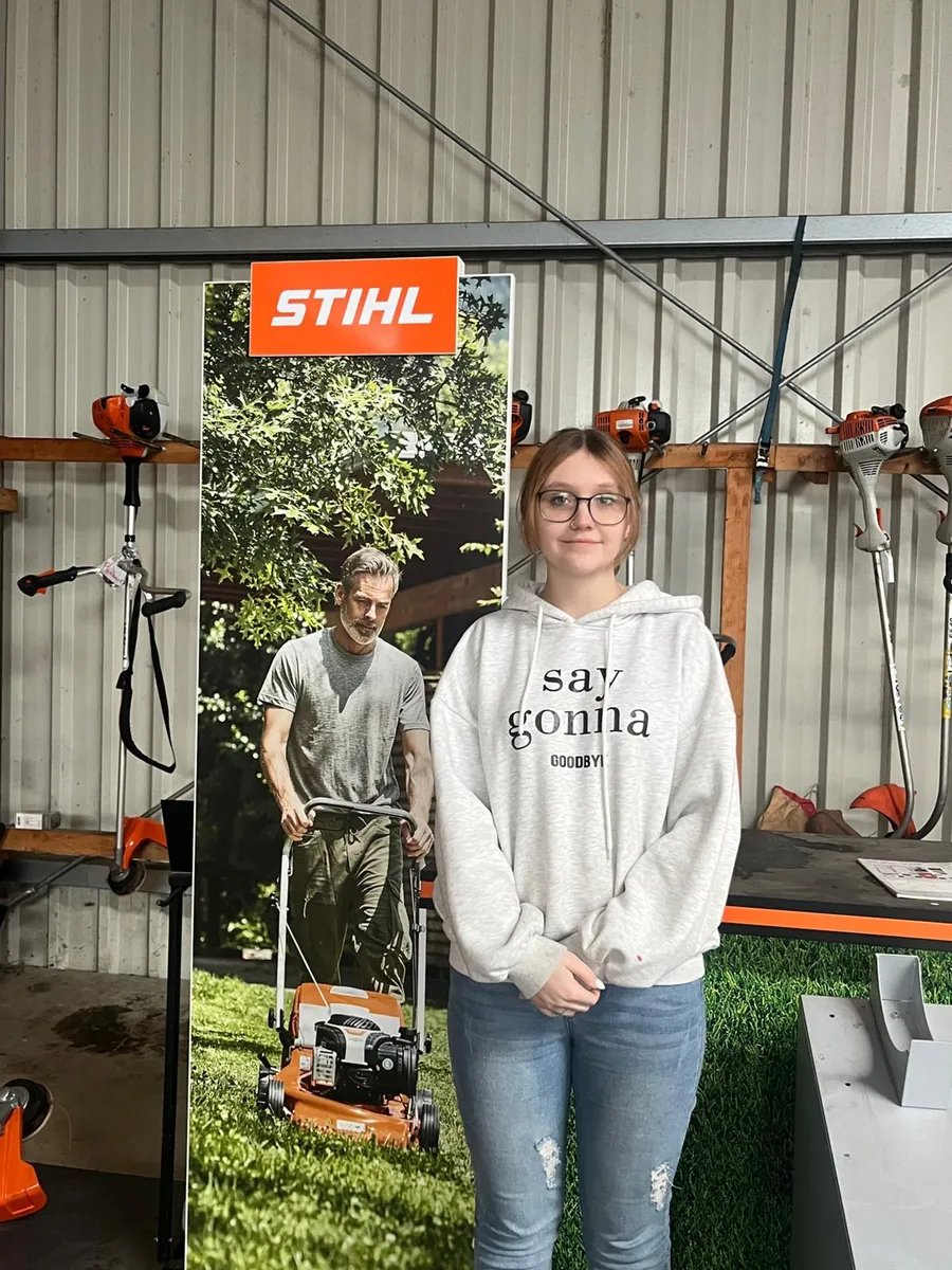 Lilli Wetzel im Verkaufsraum vor einem Stihl-Aufsteller